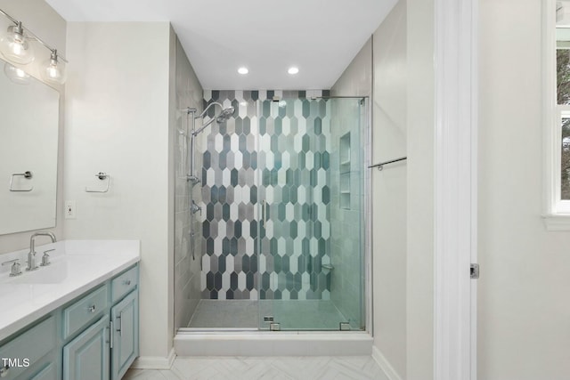 bathroom featuring baseboards, a stall shower, vanity, and recessed lighting