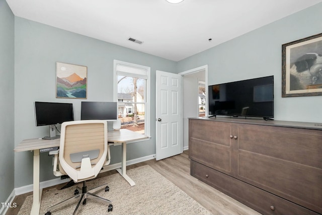 office area featuring baseboards, visible vents, and light wood finished floors