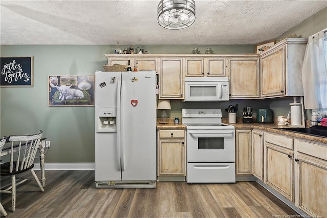 kitchen with light brown cabinetry, white appliances, and dark wood-type flooring