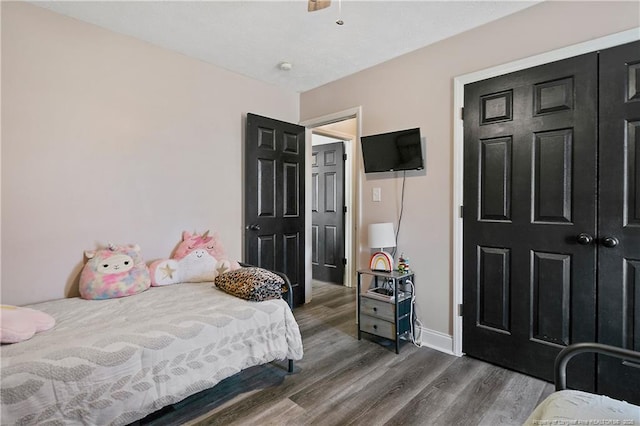 bedroom featuring baseboards and dark wood finished floors