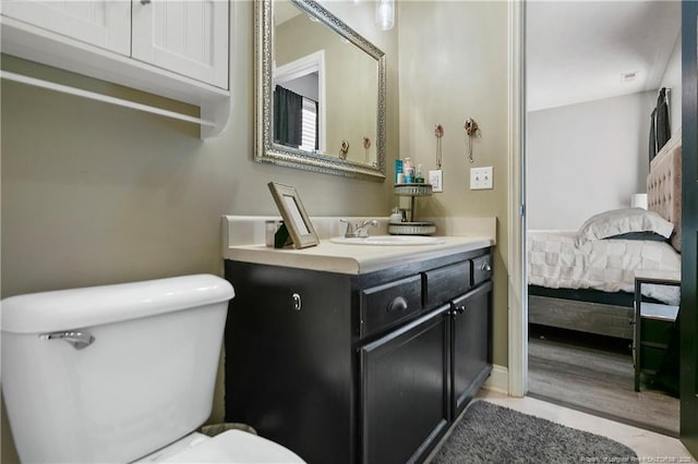 bathroom featuring vanity, toilet, and ensuite bathroom