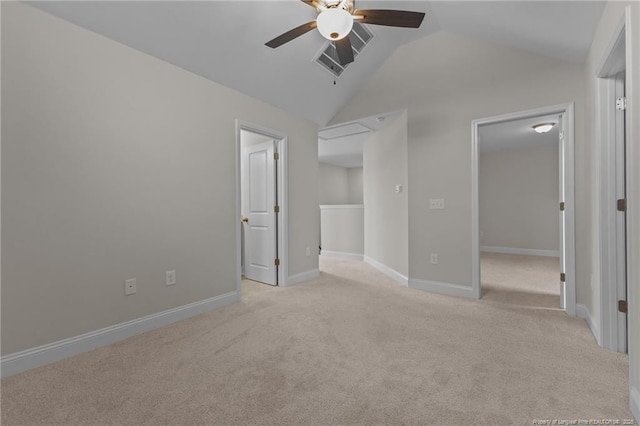 unfurnished bedroom with lofted ceiling, carpet, visible vents, and baseboards