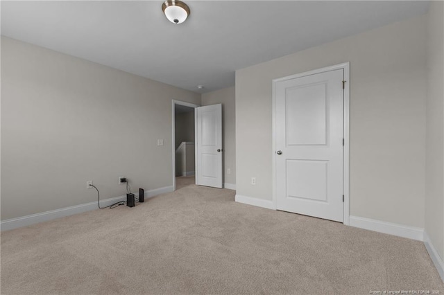 unfurnished bedroom with carpet and baseboards