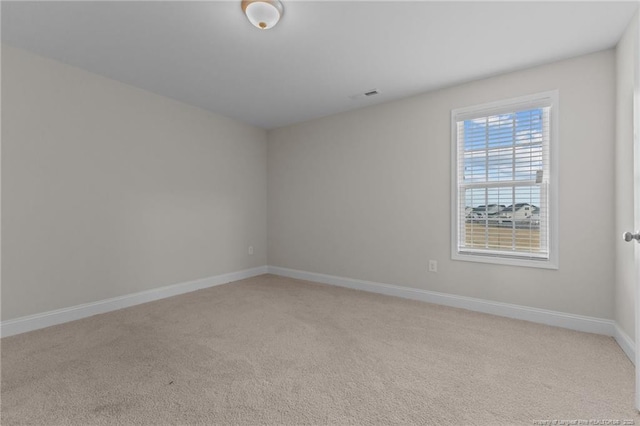 unfurnished room with light carpet, baseboards, and visible vents