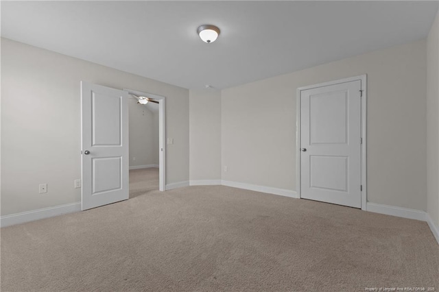 empty room with light carpet and baseboards