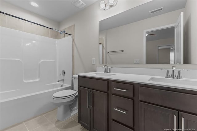 full bathroom featuring toilet, double vanity, a sink, and visible vents