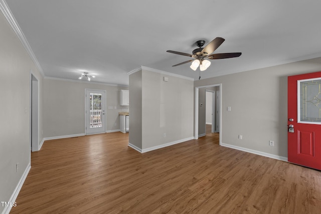 unfurnished living room featuring light wood-style floors, ornamental molding, baseboards, and a ceiling fan