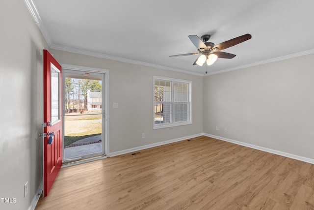 entryway featuring baseboards, crown molding, and light wood finished floors