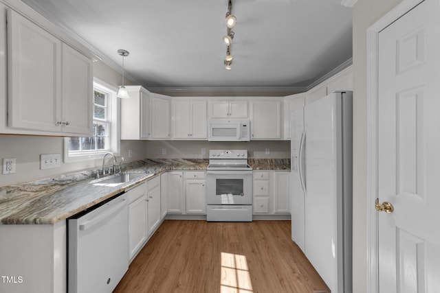 kitchen with white appliances, white cabinetry, a sink, and light wood-style flooring