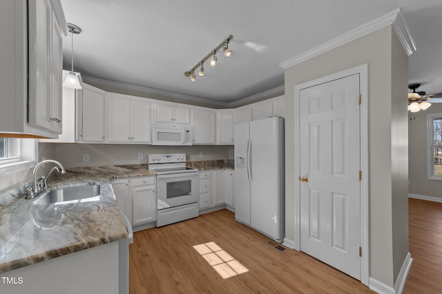 kitchen with ornamental molding, white appliances, light wood finished floors, and a sink