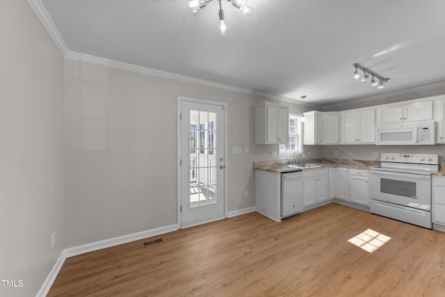 kitchen with crown molding, light wood finished floors, white cabinets, white appliances, and baseboards