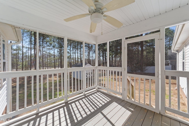 unfurnished sunroom featuring a ceiling fan