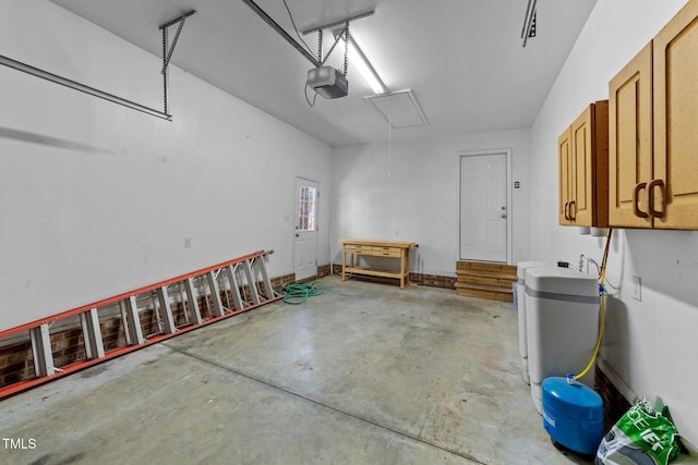 garage featuring a garage door opener and baseboards