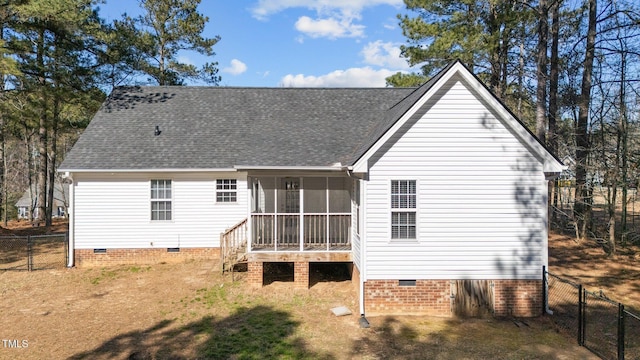 rear view of house with roof with shingles, crawl space, fence, and a sunroom