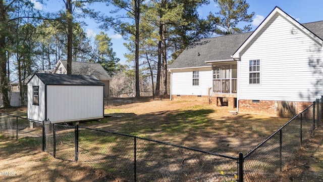 exterior space featuring an outbuilding, a storage unit, and a fenced front yard