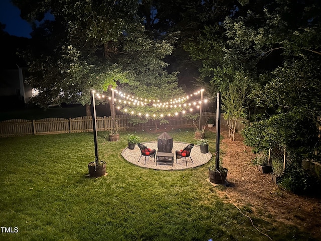 yard at twilight with a patio and a fenced backyard