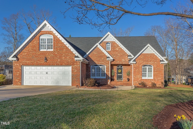 traditional-style home featuring brick siding, driveway, a shingled roof, and a front yard