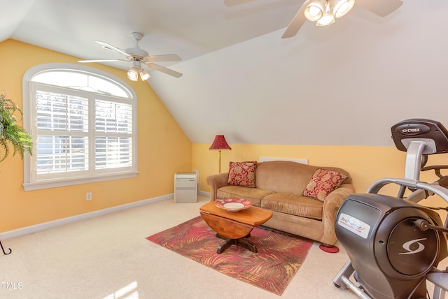 carpeted living area featuring lofted ceiling, baseboards, and ceiling fan