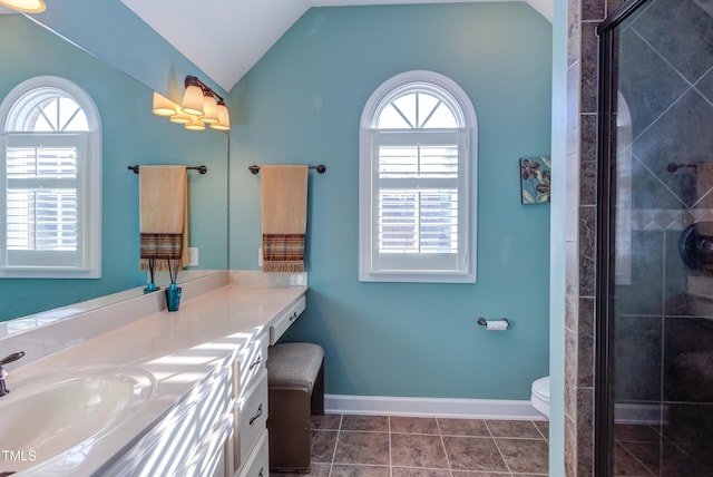 bathroom with tile patterned floors, lofted ceiling, a healthy amount of sunlight, and a shower stall