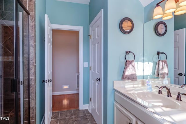 full bathroom with visible vents, a stall shower, tile patterned flooring, baseboards, and vanity