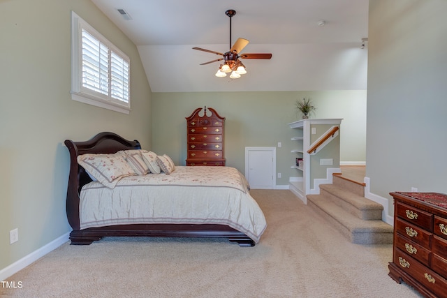 bedroom with vaulted ceiling, carpet flooring, baseboards, and visible vents