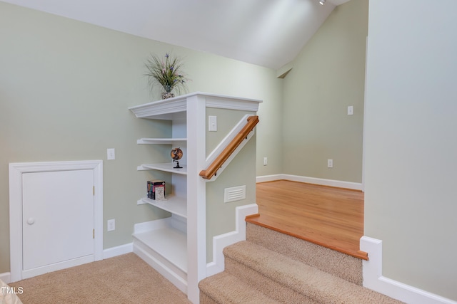 stairs featuring baseboards, carpet floors, lofted ceiling, and visible vents