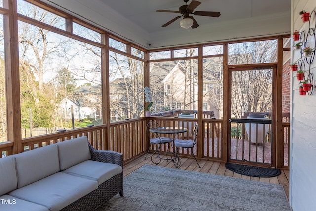 sunroom featuring a ceiling fan