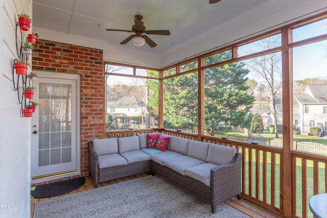 unfurnished sunroom with ceiling fan