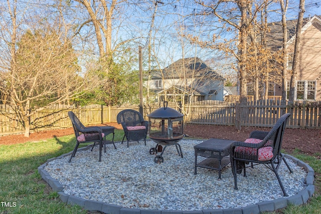 view of patio with a fenced backyard and an outdoor fire pit