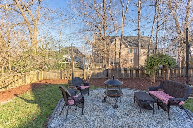 view of yard featuring a fire pit, a fenced backyard, and a patio area