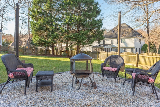 view of yard with a patio, a fenced backyard, and a fire pit