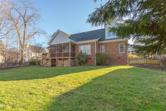 rear view of house with roof with shingles, a fenced backyard, a sunroom, a lawn, and brick siding