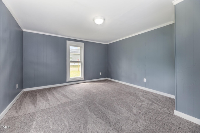 unfurnished room featuring ornamental molding, carpet flooring, and baseboards