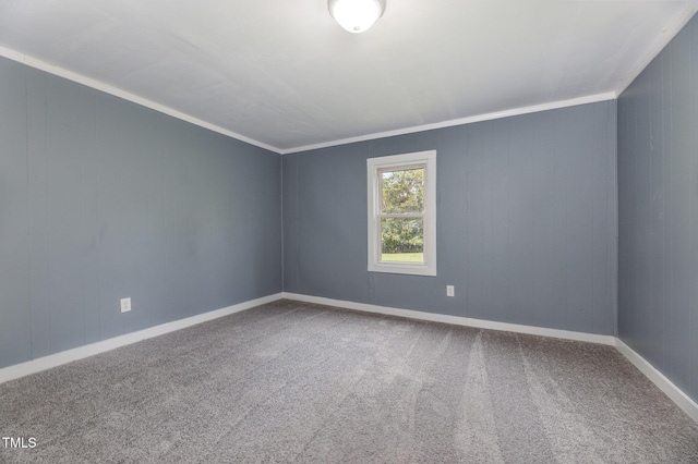 unfurnished room with ornamental molding, carpet flooring, and baseboards