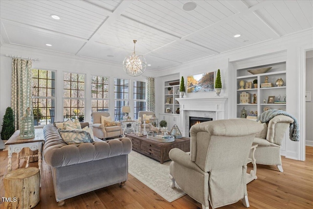 living area with built in features, coffered ceiling, a lit fireplace, and wood finished floors