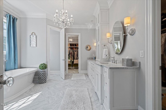 bathroom with a freestanding bath, a spacious closet, ornamental molding, vanity, and baseboards