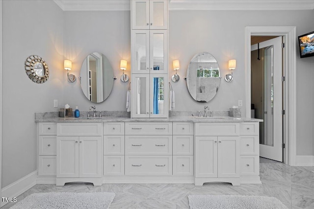 bathroom featuring marble finish floor, double vanity, a sink, and crown molding