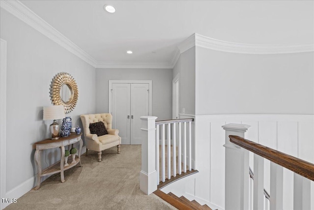 hallway featuring wainscoting, light colored carpet, crown molding, an upstairs landing, and recessed lighting