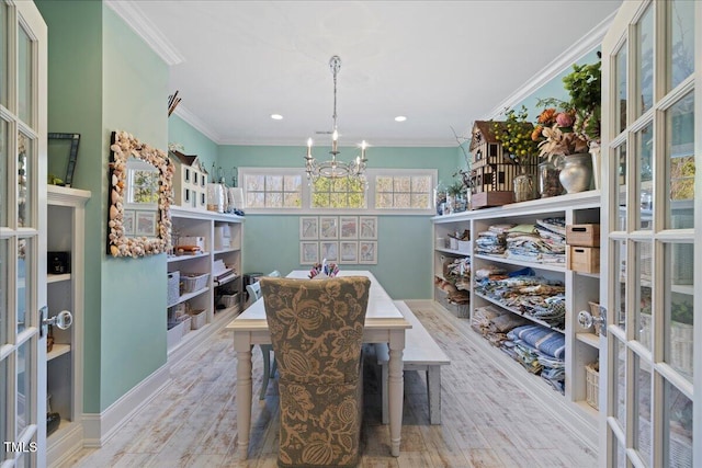 dining area featuring french doors, crown molding, an inviting chandelier, and wood finished floors