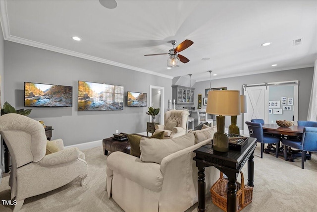 living area featuring ornamental molding, a barn door, visible vents, and light colored carpet