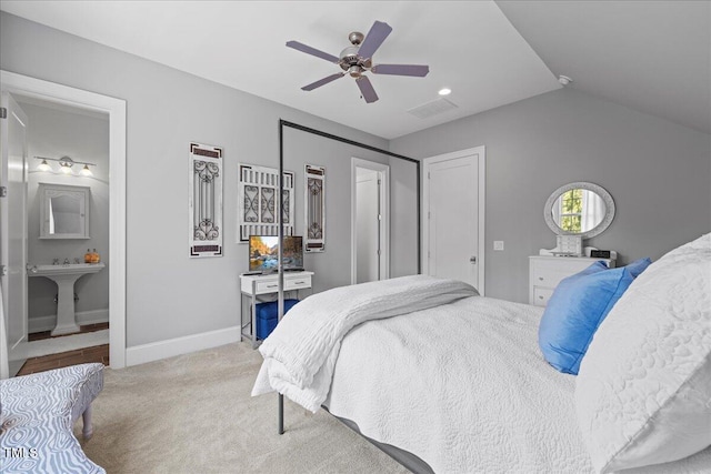 bedroom with light colored carpet, a sink, a ceiling fan, baseboards, and visible vents