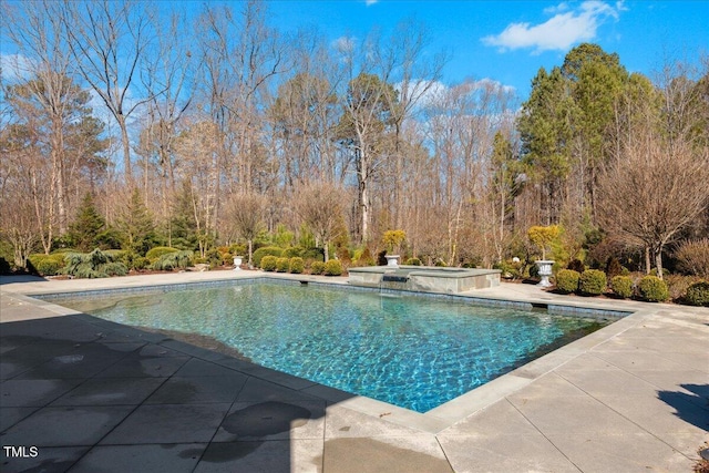 view of pool featuring a pool with connected hot tub and a patio area