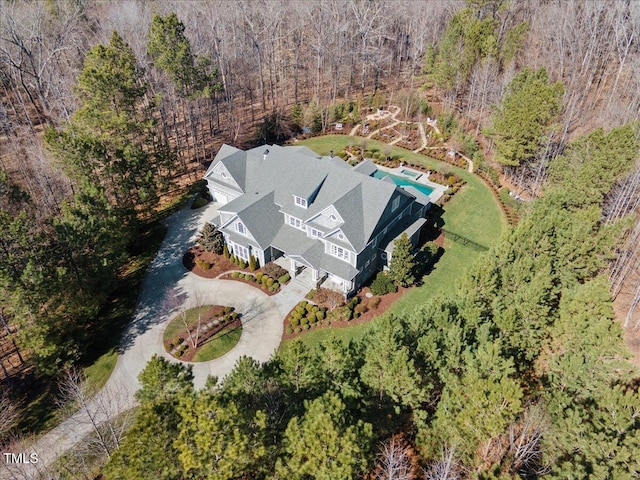 birds eye view of property featuring a view of trees