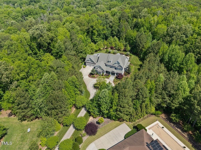 birds eye view of property featuring a view of trees