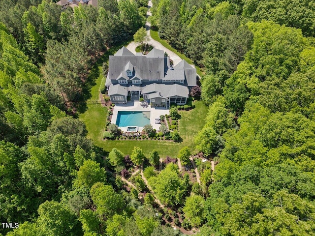 birds eye view of property with a forest view
