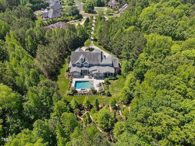 aerial view featuring a wooded view