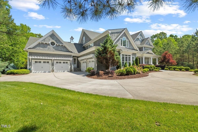view of front of house with driveway, a front lawn, and a garage