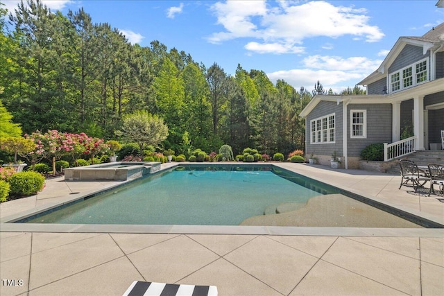 view of pool with a pool with connected hot tub and a patio