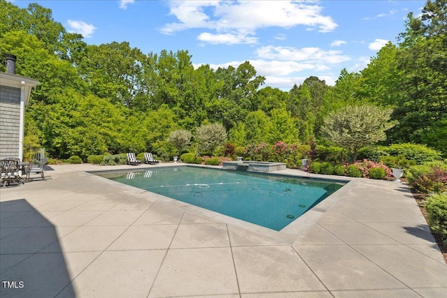view of pool with a patio and a pool with connected hot tub