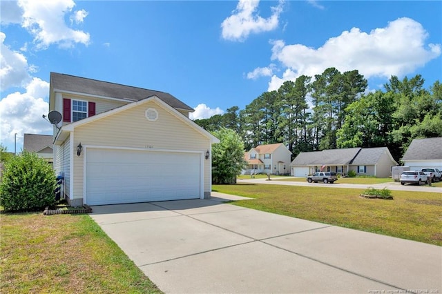 view of side of property with concrete driveway and a yard